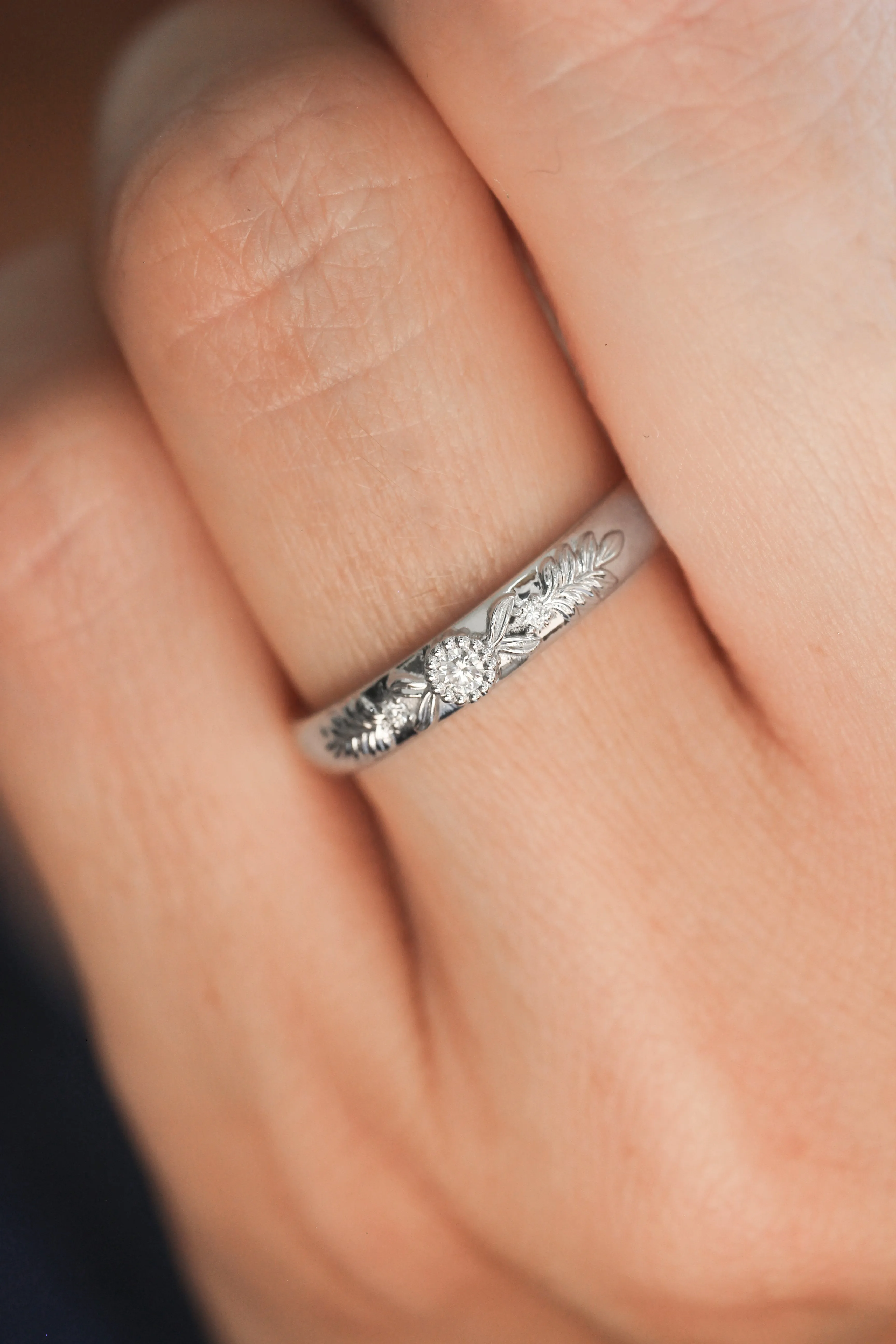 White gold wedding band with three diamonds, wreath ring